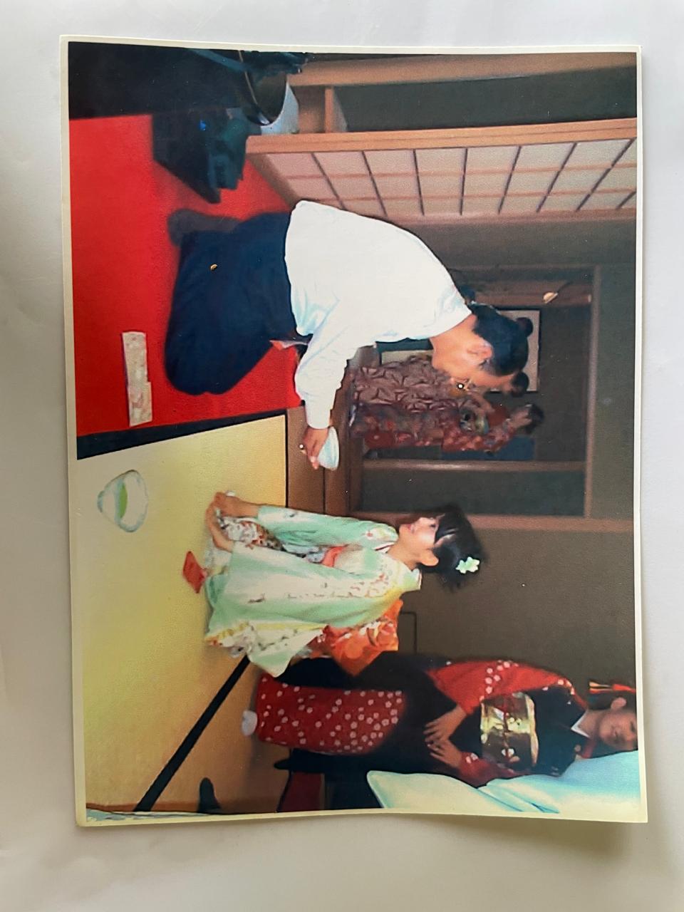 A bright pink sheet of paper used to wrap flowers curves in front of rich blue background