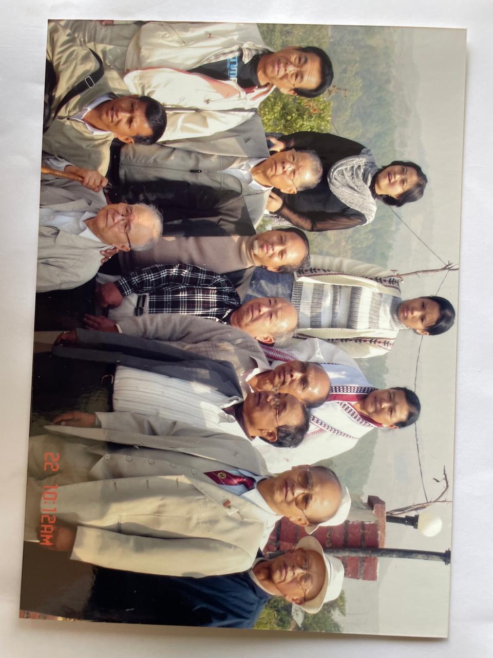A bright pink sheet of paper used to wrap flowers curves in front of rich blue background