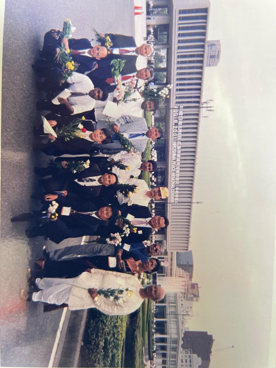 A bright pink sheet of paper used to wrap flowers curves in front of rich blue background